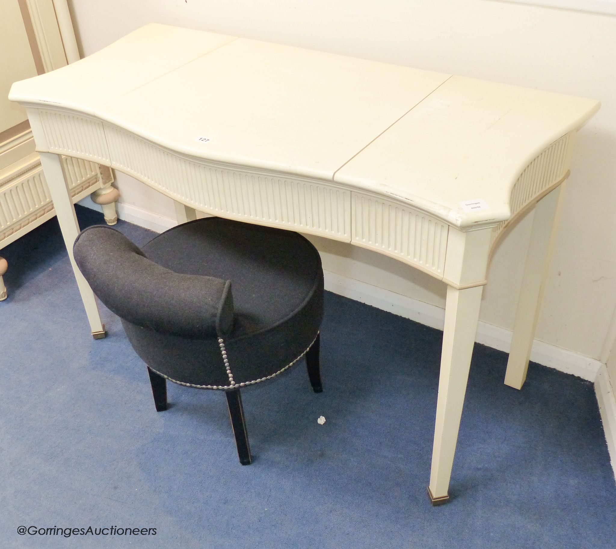 A cream and parcel gilt 'eclectic' dressing table by And So To Bed, 120 cm wide, 54cm deep, 77 cm high, together with an Eichholtz stool